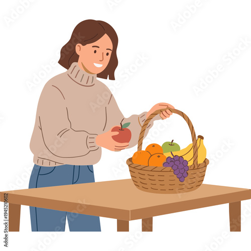 Woman picks an apple from a basket of assorted fruits on a table indoors.