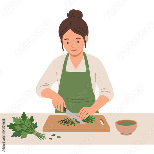 Woman chopping herbs on a cutting board in the kitchen with apron