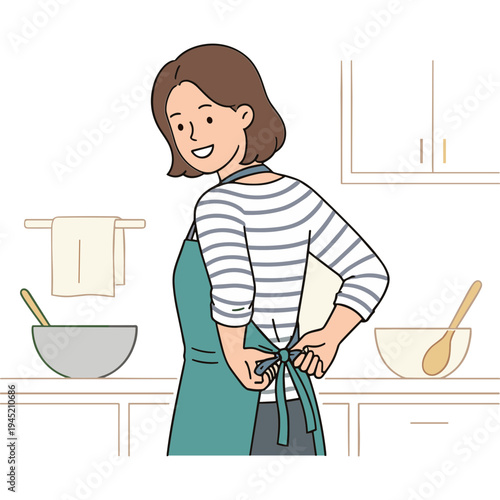 Woman wearing apron standing in kitchen with bowls and utensils nearby smiling