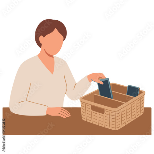 Woman placing phone into wicker basket on brown table indoors