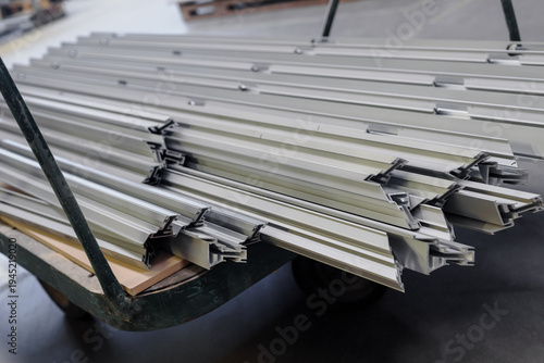 Metal profile pipe of rectangular cross section in packs at the warehouse. Metal profiles on cart in warehouse for furniture production