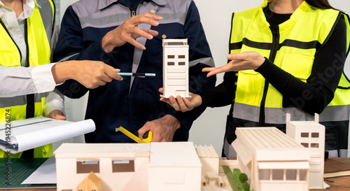 Engineer teams meeting working together wear worker helmets hardhat on construction site in modern city.Asian industry professional team
