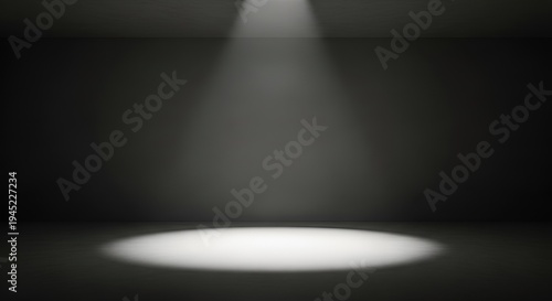 Dramatic spotlight shining down on empty dark background with spotlight effect
