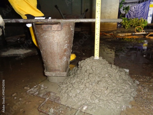 Photography Dimly Lit Construction Site Slump Test Showing Concrete Pile from Rusty Metal Co