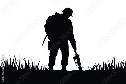 Silhouette of a soldier with rifle in a grassy field