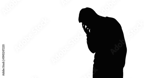 Silhouette of a man in despair, head in hands, isolated on white background
