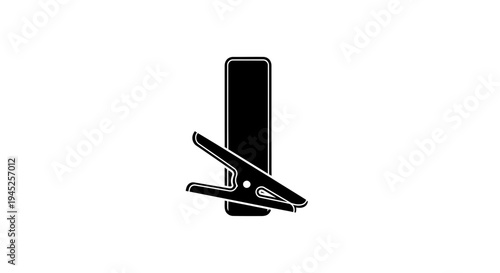 Black Clothes Pin Clipping on a Black Rectangular Object