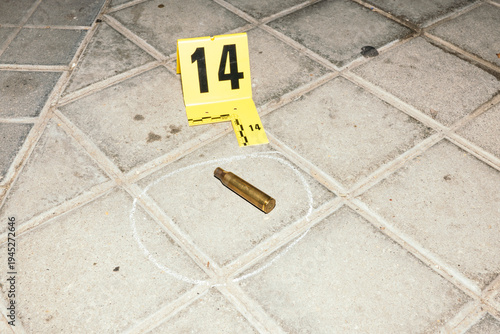 Bullet casing marked as evidence at crime scene