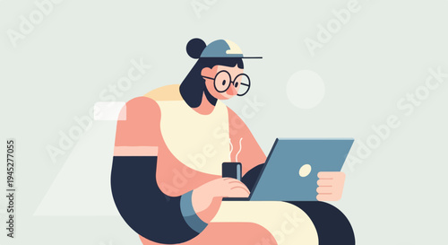 Person with glasses and cap working on laptop, holding a hot drink