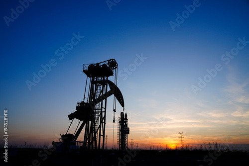 The oil pump, industrial equipment. Oil field site, oil pumps are running.