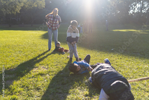 Children and adult playing outdoor game in park
