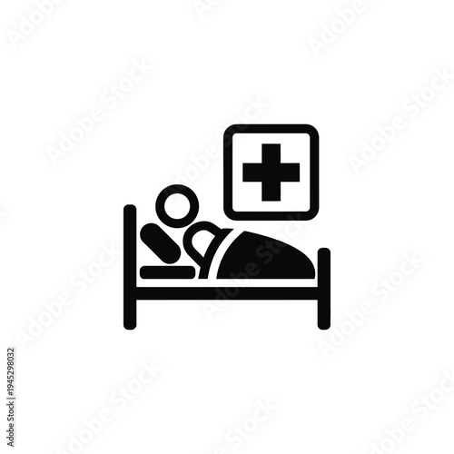 A person lies in a hospital bed with a medical sign