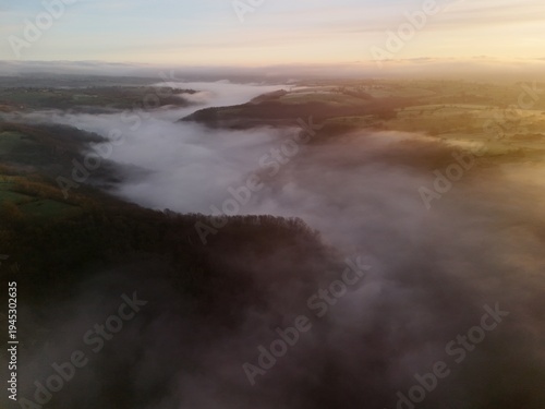 Hills countryside sunrise in morning fog - Arial drone view
