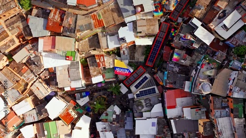 Wallpaper Mural Top down drone view of Comuna 13 in Medellin, Colombia, capturing dense hillside housing, narrow streets, and the layered urban texture of this iconic neighborhood from above. Torontodigital.ca