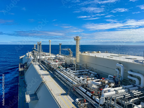 LNG carrier ship deck with complex pipeline system sailing in open ocean, global gas energy transport and maritime logistics. Membrane type tank NO96 