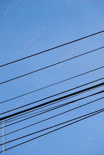 Wallpaper Mural Lines in the sky. A minimalist shot of power cables crossing a clear sky, vibrant blue background Torontodigital.ca