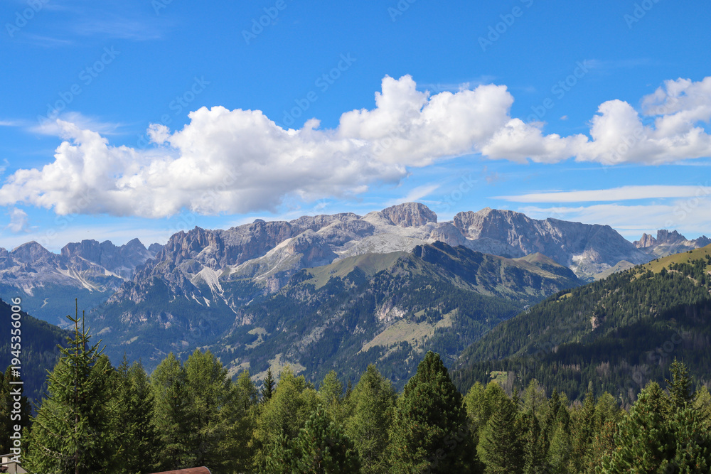 Fototapeta premium White cumulus clouds hugging mountain tops
