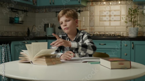 Boy Pausing Homework to Secretly Play on Phone
