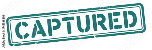 A green rectangular stamp displays the word captured in bold uppercase letters