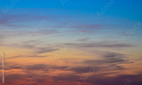 Layered blue and golden sunset sky with fine horizontal lines.