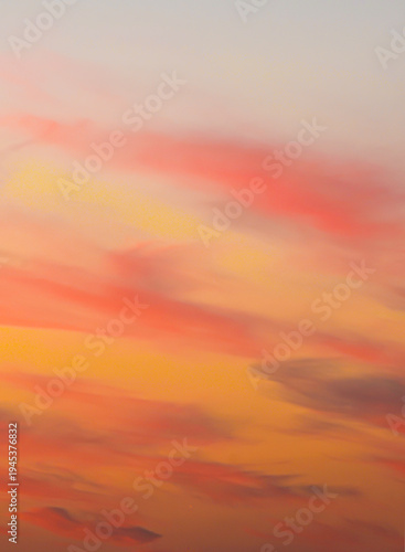 Vibrant orange, yellow, and red sunset cloud layers background texture