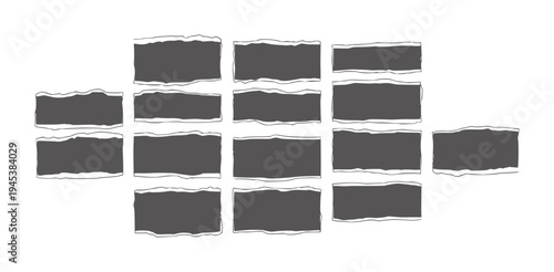 Scattered dark gray rectangular shapes with torn paper edges white abstract texture