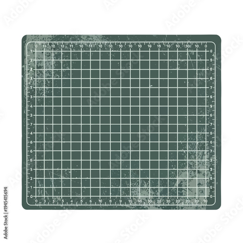 Green cutting mat with grid and ruler markings, isolated on white background