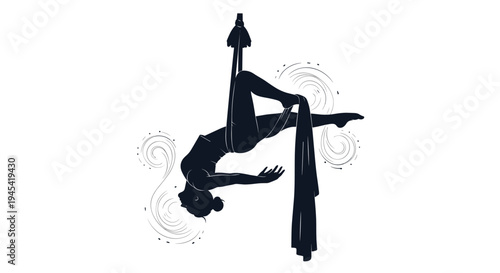 Silhouette of a graceful aerial silk dancer performing an acrobatic pose while hanging from a long fabric in the air.