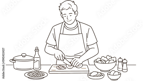 A man in an apron cutting tomatoes on a kitchen counter