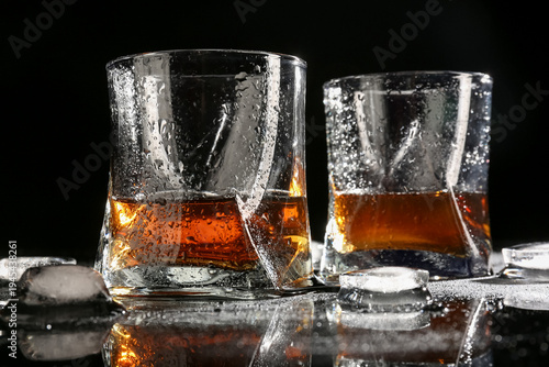 Glasses of whiskey with wat...