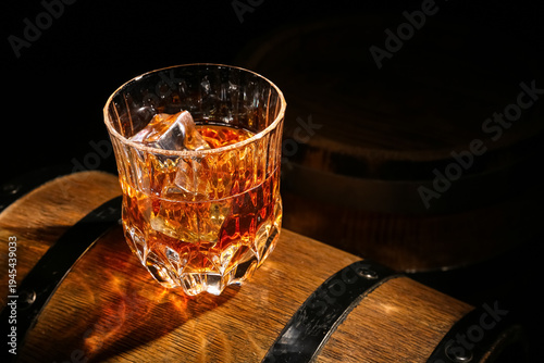 Glass of cold whiskey on wo...