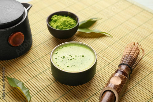 Canvastavla Bamboo mat with cup of fresh matcha tea, powder, chasen and teapot, closeup