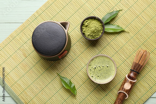 Konstfotografi Traditional matcha tea set with whisk, teapot, frothy green tea and powder on ba