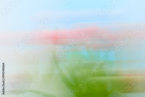 Abstract Motion Blur of Pink Flowers and Green Foliage Background