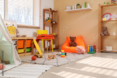 Interior of children's playroom with shelf units and toys