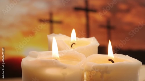 Three burning candles against the background of three crosses symbolizing the death and resurrection of Jesus Christ and as a symbol of Easter.