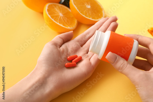Female hands with vitamin C...