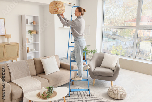 Young woman on stepladder s...