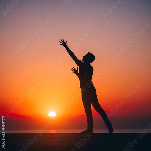 A silhouette of a person standing on a cliff with their arms raised at sunset