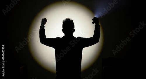 A man holds up a flashlight in the dark