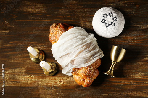 Canvas Print Traditional challah bread with wine goblet, kipa and burning candles on wooden table
