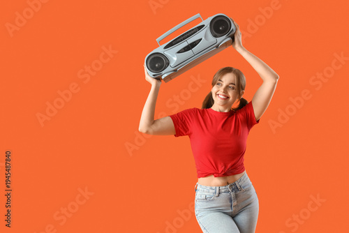 Young woman with boombox on...