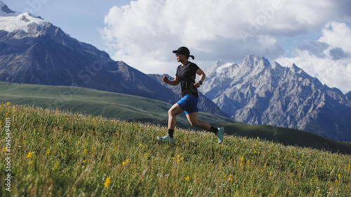 Woman runner running up on grassland mountain