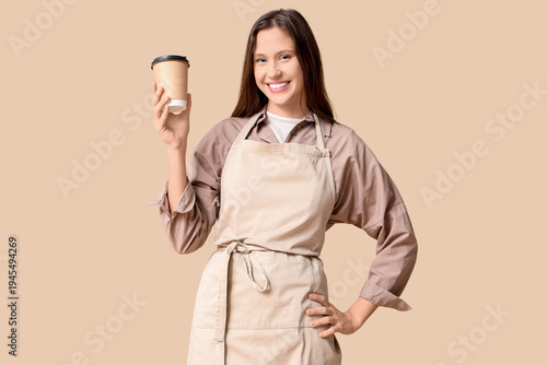 Happy young female barista ...