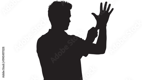 Man silhouette putting on a black latex glove, preparing for work or a medical procedure featuring preparation, hand, finger with wrist and arm