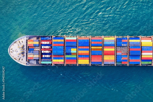Stock images of Ship carrying containers with crude oil barrels from the harbour. Ship blocked in harbour.