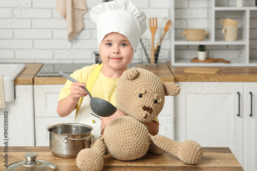 Little happy chef feeding t...