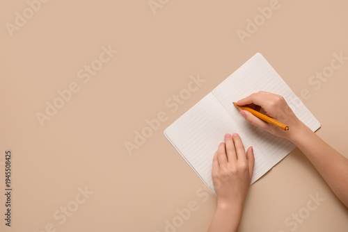 Female hands writing in not...