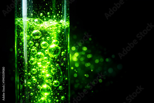 Emerald Elixir: An arresting image of a test tube filled with a luminescent, bubbly green liquid, glowing against a stark black backdrop, suggesting scientific discovery and experimentation.