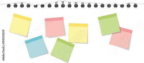 Colorful sticky notes on a spiral notebook page with various colored sheets